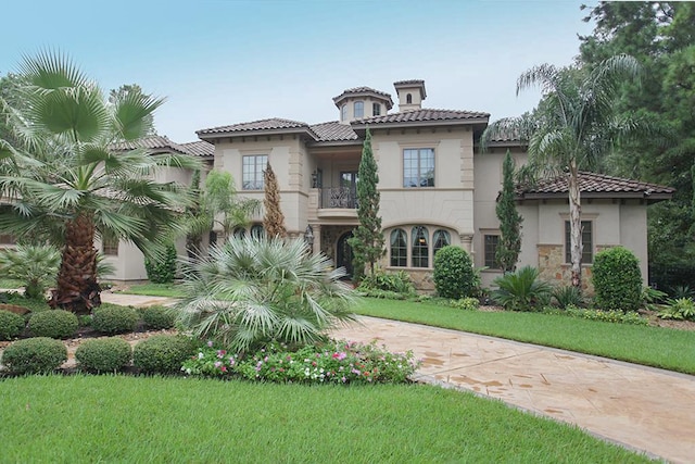 mediterranean / spanish-style home featuring a front lawn