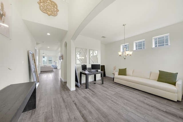 living room with an inviting chandelier and light hardwood / wood-style flooring