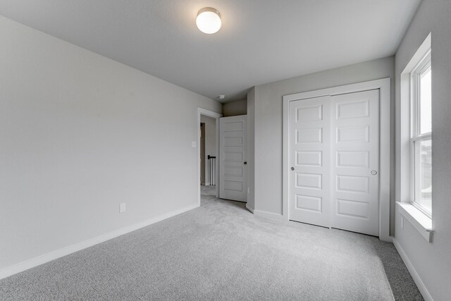 22126 Oceania Shores Dr, Hockley, TX 77447 - unfurnished bedroom with carpet flooring, baseboards, and a closet