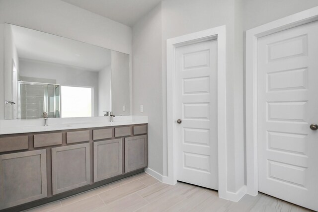 22126 Oceania Shores Dr, Hockley, TX 77447 - full bathroom with a shower stall, double vanity, and baseboards