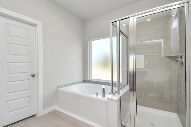 22126 Oceania Shores Dr, Hockley, TX 77447 - full bath with a shower stall, a bath, baseboards, and wood finished floors