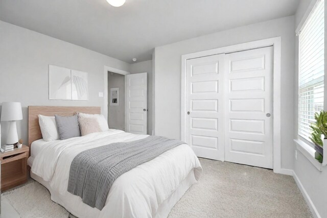 22126 Oceania Shores Dr, Hockley, TX 77447 - bedroom with light carpet, a closet, multiple windows, and baseboards