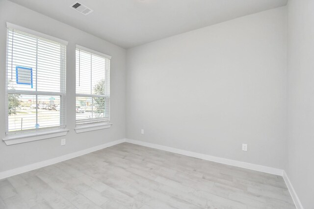 22126 Oceania Shores Dr, Hockley, TX 77447 - spare room with baseboards and light wood-style flooring