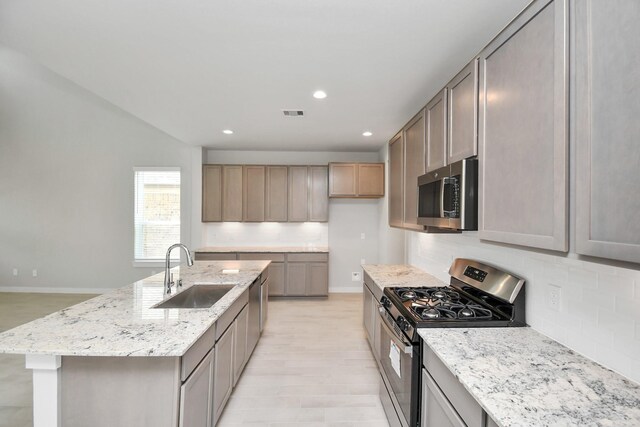 22126 Oceania Shores Dr, Hockley, TX 77447 - kitchen with stainless steel appliances, a sink, backsplash, light stone countertops, and recessed lighting