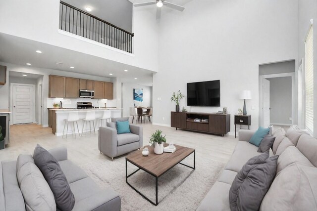 22126 Oceania Shores Dr, Hockley, TX 77447 - living room featuring a high ceiling, a ceiling fan, baseboards, and recessed lighting