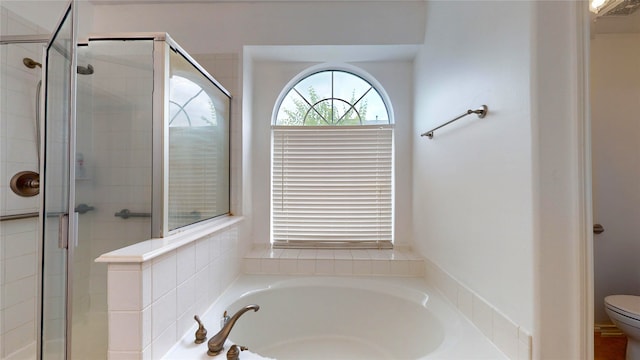 bathroom featuring toilet and independent shower and bath