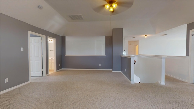 carpeted empty room with ceiling fan and lofted ceiling