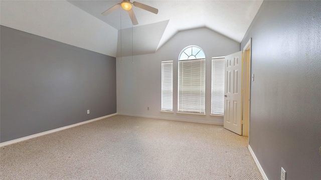 spare room with lofted ceiling, light colored carpet, and ceiling fan