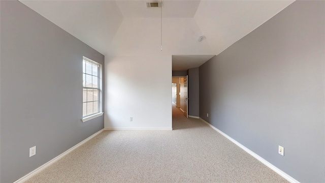 empty room with light carpet and lofted ceiling