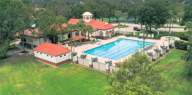 view of swimming pool featuring a lawn and a patio