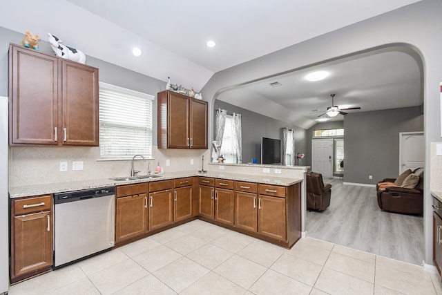 kitchen featuring light wood-type flooring, sink, dishwasher, lofted ceiling, and ceiling fan