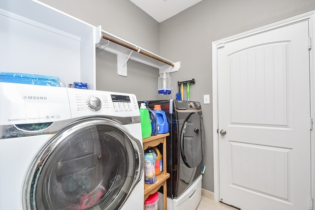 clothes washing area with washing machine and dryer