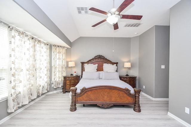 bedroom featuring light wood-type flooring, lofted ceiling, and ceiling fan