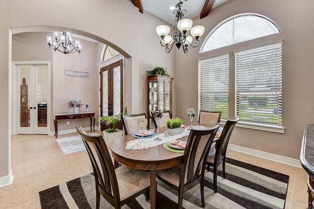 tiled dining area with a healthy amount of sunlight, french doors, and beam ceiling