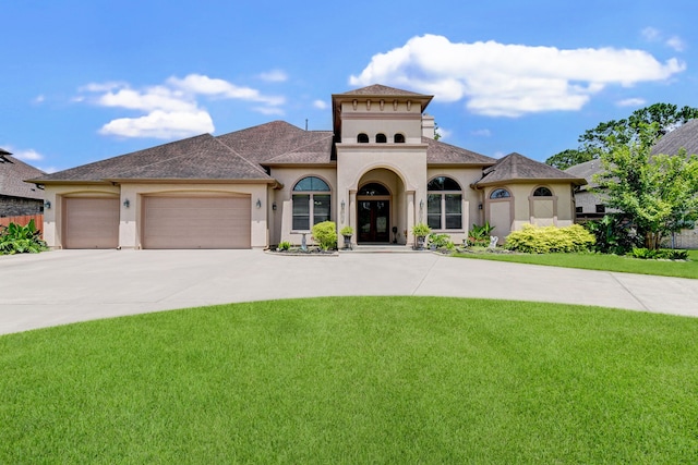 mediterranean / spanish-style home featuring a garage and a front yard