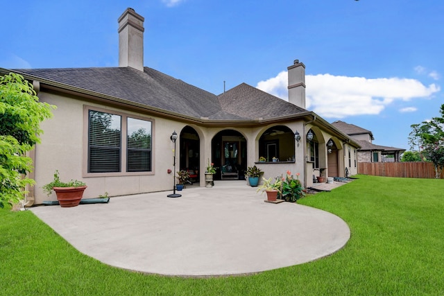 back of property with a patio area and a lawn