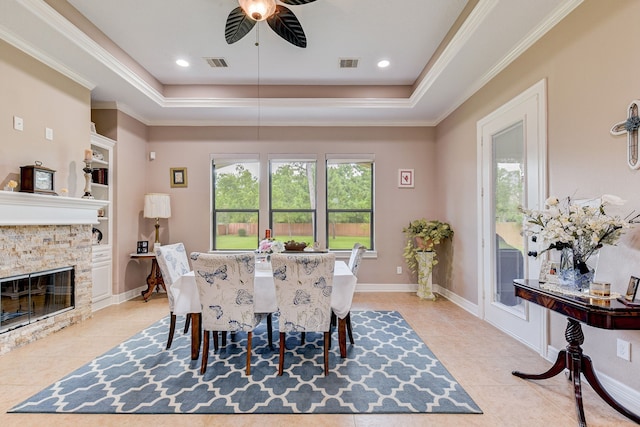 dining room featuring ornamental molding, a raised ceiling, light tile patterned floors, and ceiling fan