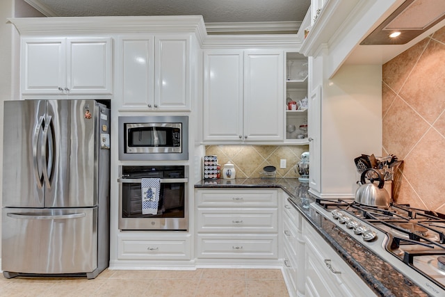 kitchen featuring dark stone counters, white cabinetry, and stainless steel appliances