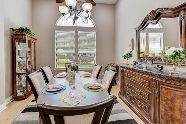 dining area with beamed ceiling, light tile patterned floors, and a notable chandelier