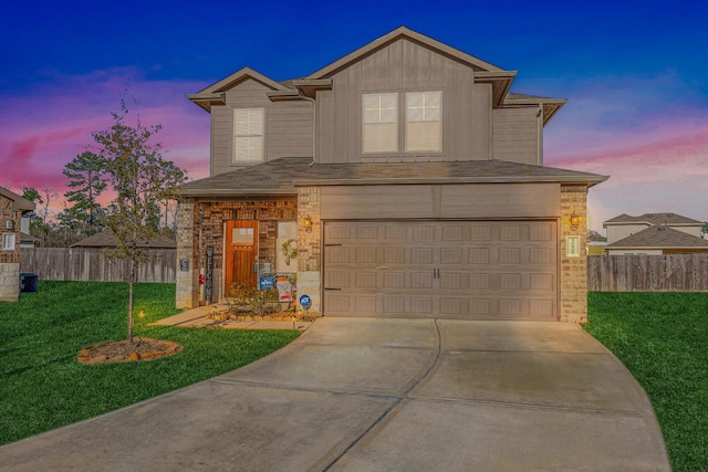 view of front of property with a garage and a yard