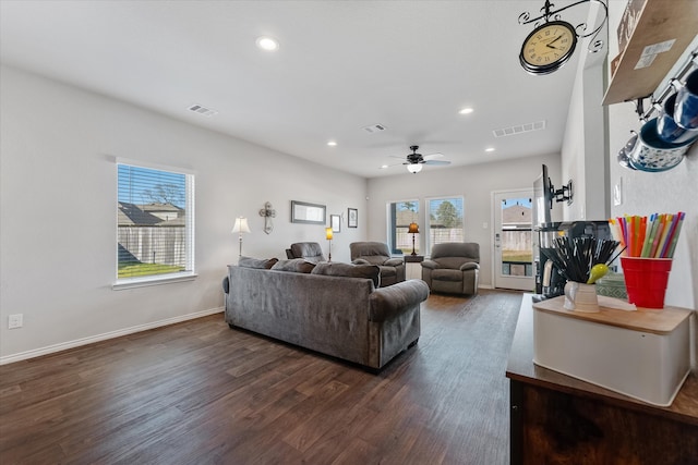 living room with ceiling fan and dark hardwood / wood-style floors