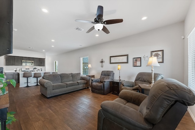 living room with ceiling fan and dark hardwood / wood-style floors