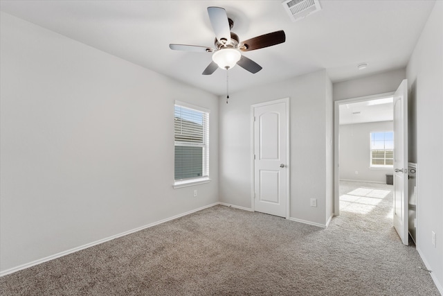 unfurnished bedroom with light colored carpet and ceiling fan