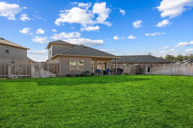 back of house with a yard