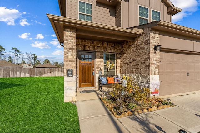 view of exterior entry with a lawn