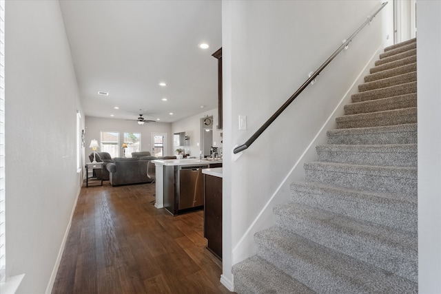 stairway with hardwood / wood-style flooring and ceiling fan