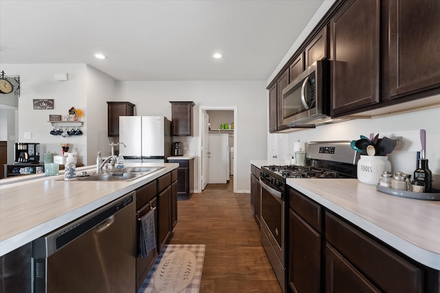 kitchen featuring stainless steel appliances, dark hardwood / wood-style floors, sink, and dark brown cabinetry