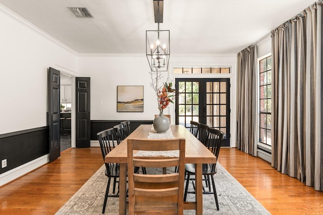 15007 Terrace Oaks Dr, Houston, TX 77068 - dining room featuring light wood finished floors, healthy amount of natural light, french doors, and ornamental molding