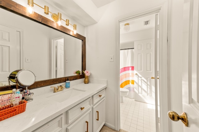 bathroom featuring tile patterned floors, vanity, curtained shower, and toilet