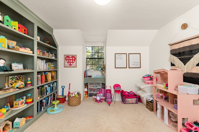 recreation room with carpet, a textured ceiling, and vaulted ceiling