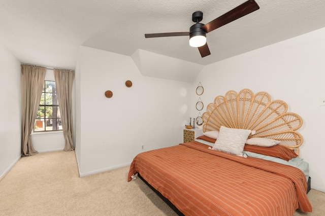 15007 Terrace Oaks Dr, Houston, TX 77068 - bedroom featuring light carpet, a ceiling fan, baseboards, vaulted ceiling, and a textured ceiling