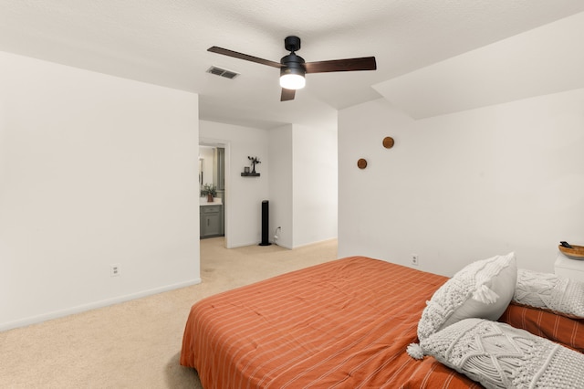 carpeted bedroom with ceiling fan and a textured ceiling