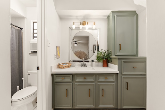 bathroom with vanity, toilet, and ceiling fan