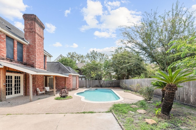 15007 Terrace Oaks Dr, Houston, TX 77068 - view of swimming pool with french doors, a patio, and a fenced backyard