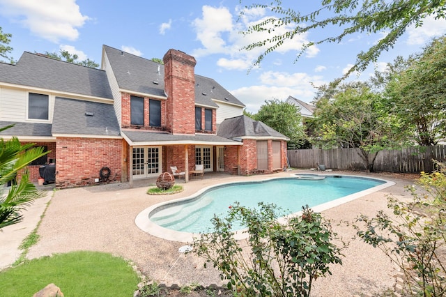 15007 Terrace Oaks Dr, Houston, TX 77068 - view of swimming pool with french doors, a patio, a fenced backyard, and an in-ground hot tub