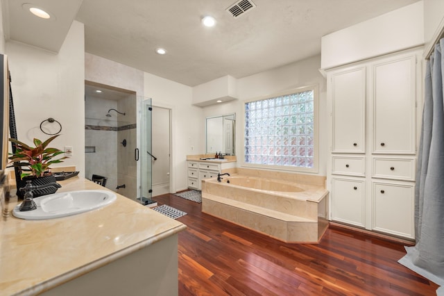 15007 Terrace Oaks Dr, Houston, TX 77068 - bathroom with a shower stall, wood finished floors, a bath, vanity, and recessed lighting