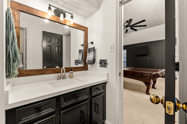 bathroom with ceiling fan, vanity, a textured ceiling, and billiards