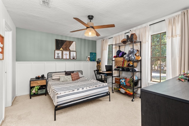 bedroom featuring carpet flooring, ceiling fan, a textured ceiling, and access to outside