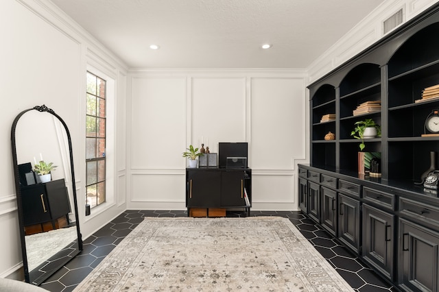 office area with built in features and ornamental molding