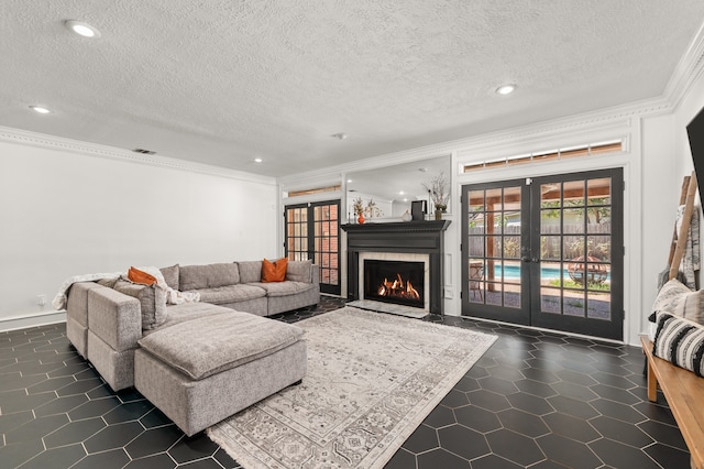 living room featuring crown molding, french doors, dark tile patterned flooring, and a textured ceiling