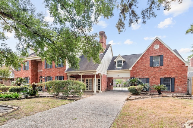 view of front of house with a front yard and french doors