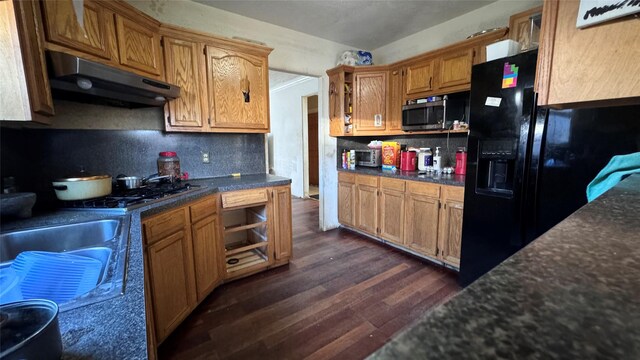 kitchen with black appliances, decorative backsplash, and dark hardwood / wood-style flooring