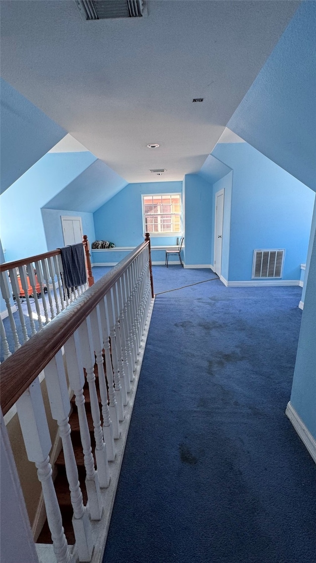 bonus room featuring carpet flooring, a textured ceiling, and lofted ceiling