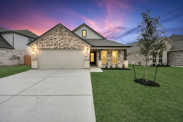 view of front of home with a garage and a yard