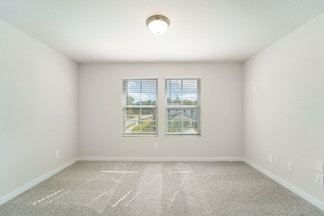 unfurnished room featuring carpet