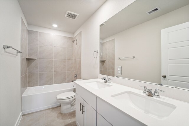 full bathroom with toilet, vanity, tiled shower / bath combo, and tile patterned floors